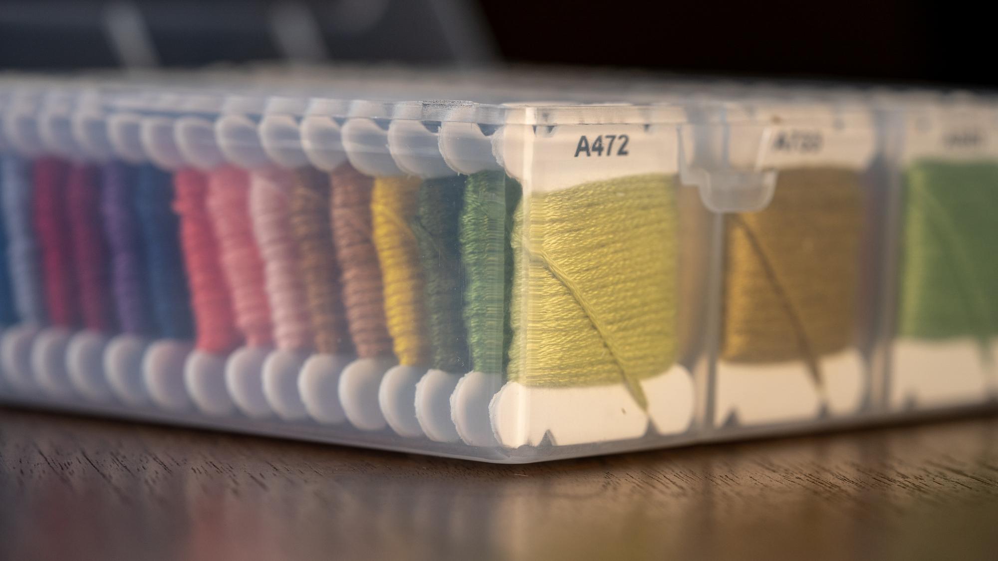 sample board with thread swatches and measurement rulers